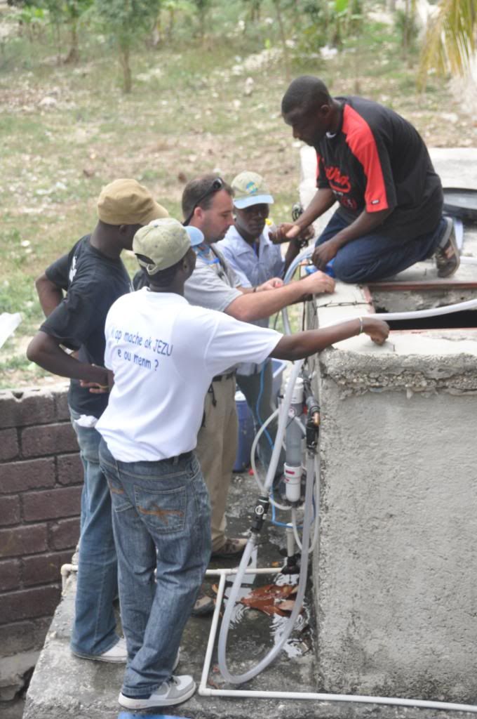 Trey teaches local Haitians to maintain a water purificaiton system